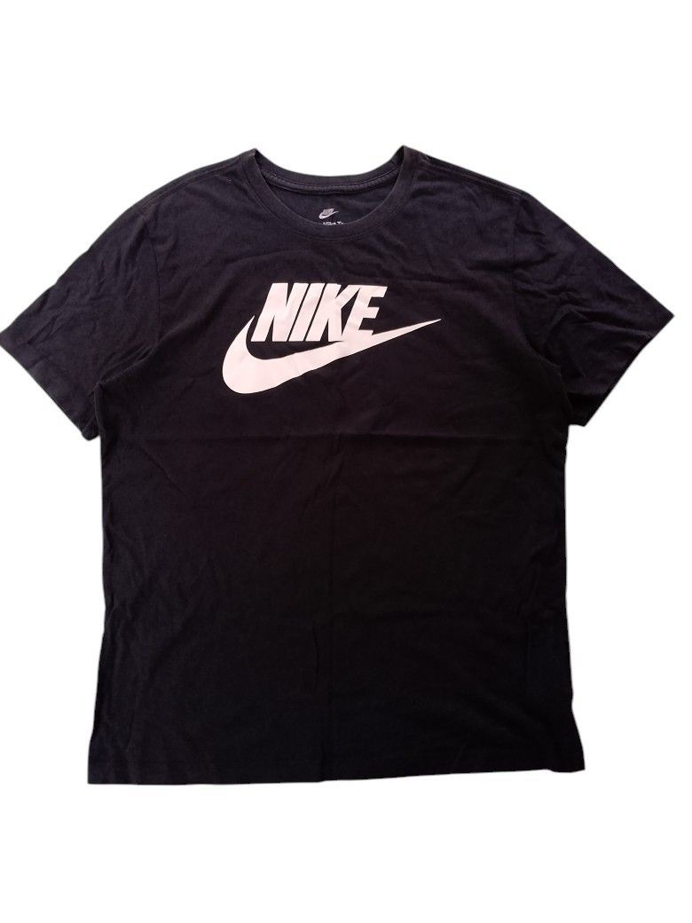 Nike Black T-Shirt with White Logo (Category: Tshirts & Polo Shirts ) located in Manila. Submitted by poisonthrift (Listing ID 1466225512, Image 1). Description: - Color: Black - Size: Large - Design: Large white Nike swoosh and lettering graphic on the chest - Fit/Material: Soft cotton fabric for a comfortable everyday fit - Style: Classic crew neckline, clean look that's easy to pair with jeans or shorts.