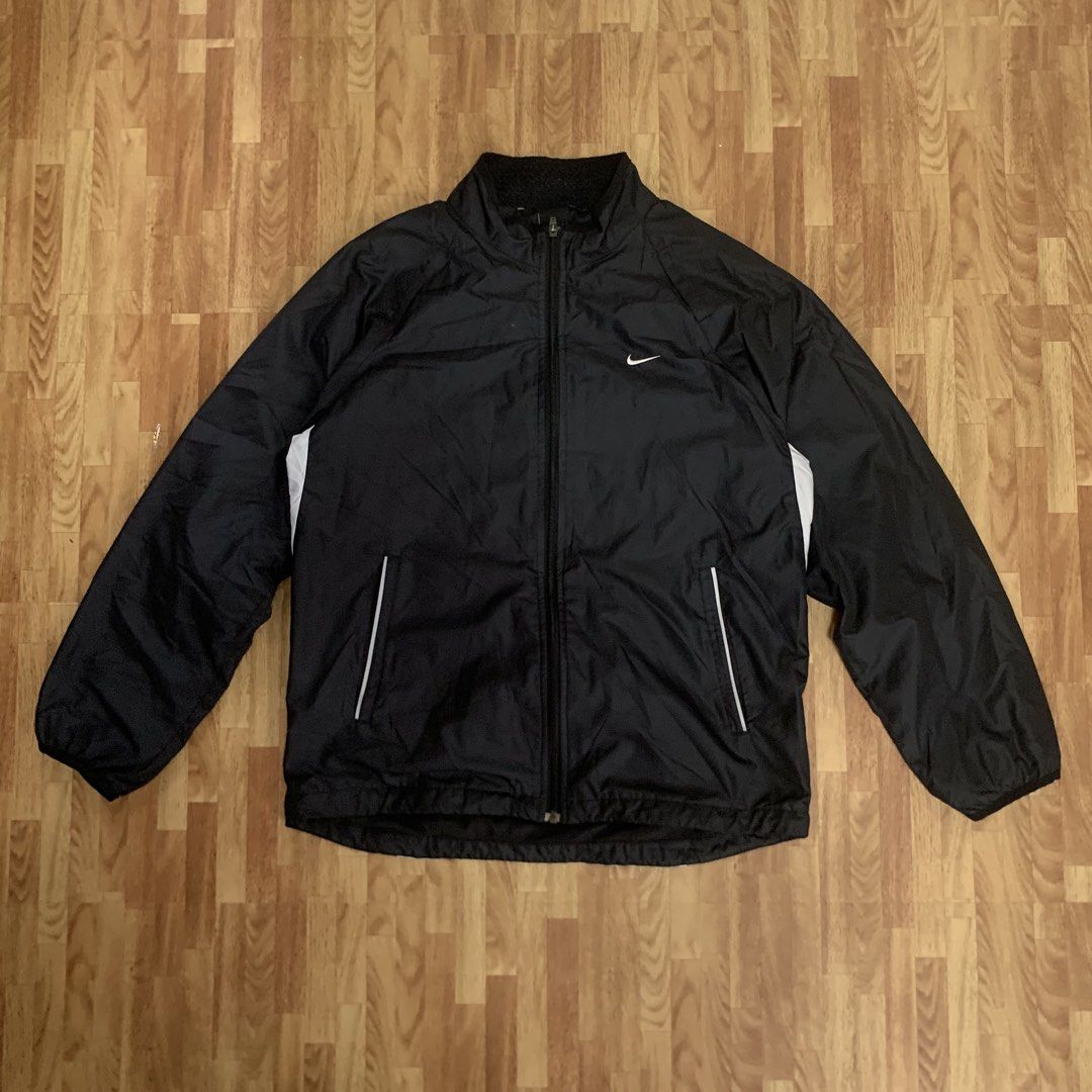 Nike Black Zip-Up Windbreaker Jacket (Category: Coats, Jackets and Outerwear) located in Cebu City. Submitted by zen.lasonking (Listing ID 1466228657, Image 1). Description: - Brand/Model: Nike Black Zip-Up Windbreaker - Size: Medium - Color: Black with white accent panels on both sides - Branding: White Swoosh logo on front left chest - Pockets: Two secure zippered side pockets with reflective piping detail - Lining: Breathable mesh lining insid
