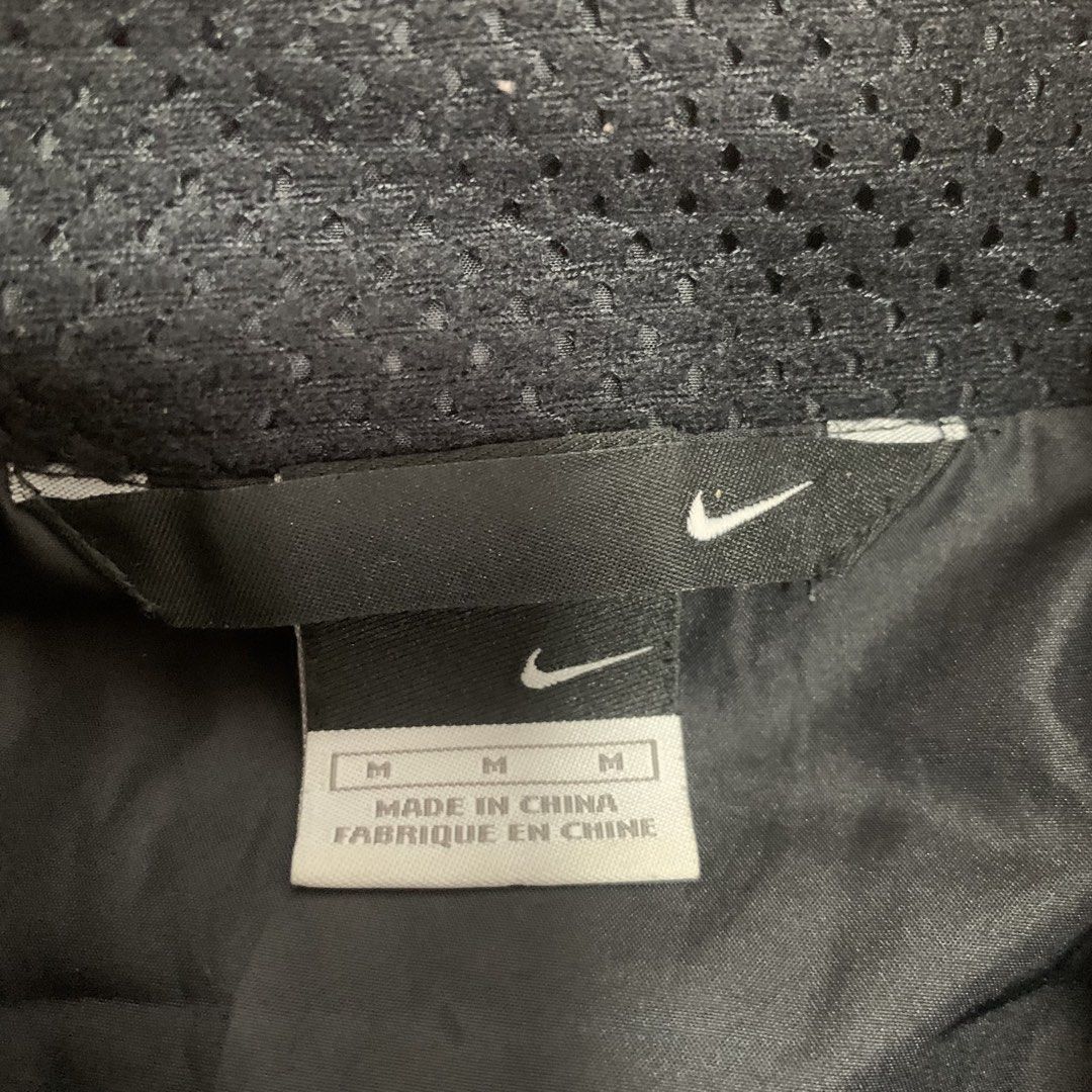 Nike Black Zip-Up Windbreaker Jacket (Category: Coats, Jackets and Outerwear) located in Cebu City. Submitted by zen.lasonking (Listing ID 1466228657, Image 3). Description: - Brand/Model: Nike Black Zip-Up Windbreaker - Size: Medium - Color: Black with white accent panels on both sides - Branding: White Swoosh logo on front left chest - Pockets: Two secure zippered side pockets with reflective piping detail - Lining: Breathable mesh lining insid