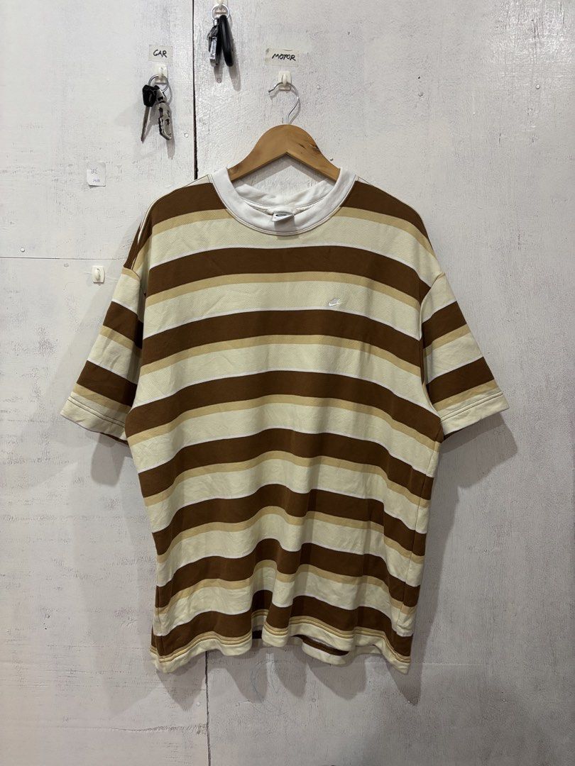 Nike Brown Striped Sweatshirt XL (Category: Coats, Jackets and Outerwear) located in Manila. Submitted by noribrahim.20 (Listing ID 1466272002, Image 1). Description: - Brand: Nike - Style: Striped crewneck sweatshirt (brown, beige, and white) - Size: XL - Details: Small embroidered swoosh on chest, large bold 'nike.' print on the back, comfortable French terry lining - Condition: Good overall with a minor smudged stain on the lower sleeve - Orig