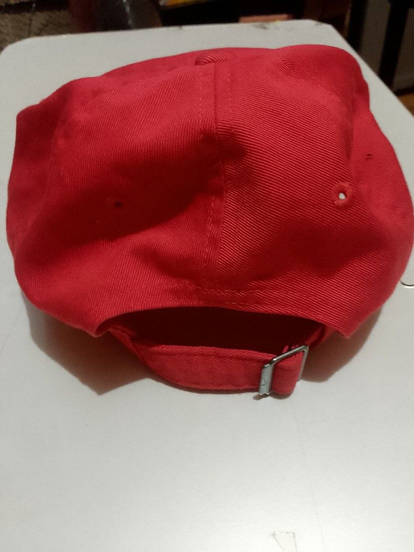 Nike Club Cap Red from US (Category: Caps & Hats) located in Manila. Submitted by martinezvp25582 (Listing ID 1466268519, Image 3). Description: - Brand: Nike - Color: Bright Red - Style: Classic curved brim with white embroidered logo - Material: 100% cotton body and lining - Size: M/L - Closure: Adjustable back strap with metal buckle - Condition: Clean fabric inside and out.