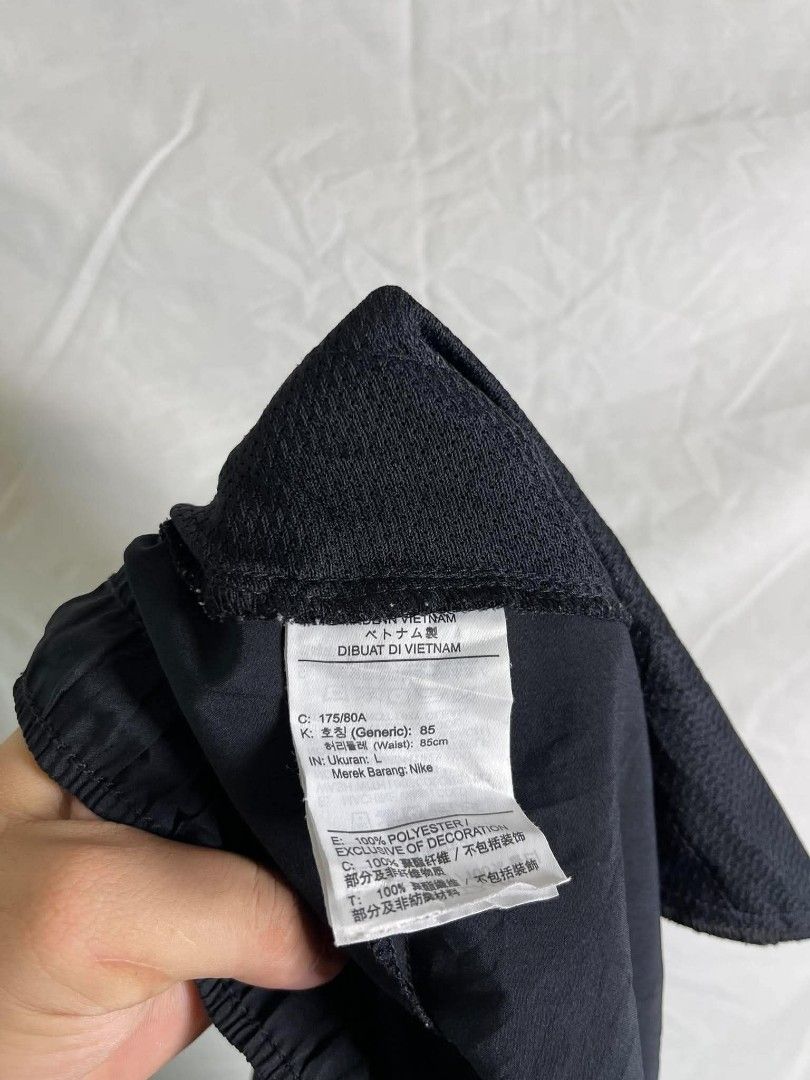 Nike Dri-FIT Black Shorts Size L (Category: Shorts) located in Manila. Submitted by japee55 (Listing ID 1466321534, Image 3). Description: - Brand: Nike - Color: Black with large white swoosh on the leg - Size: L - Material: 100% Dri-FIT polyester (lightweight & quick-drying) - Features: Elastic waistband with adjustable fit - Origin: Made in Vietnam.