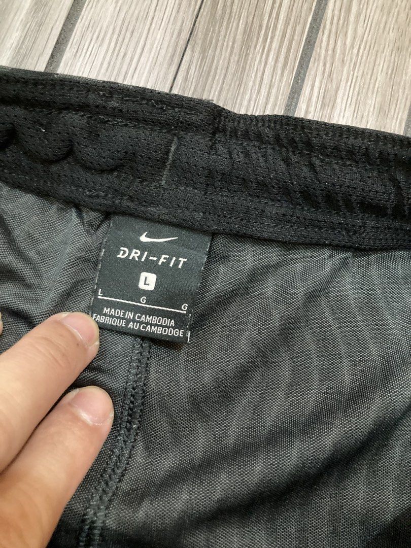 Nike Dri-FIT Patterned Athletic Shorts Size L (Category: Shorts) located in Trece Martires City. Submitted by thriftkoto.91 (Listing ID 1466256361, Image 3). Description: Nike Dri-FIT athletic shorts in black with a wavy fingerprint style graphic pattern throughout. Size large tag inside waistband. Elastic waist design with solid black side panels and reflective Nike swoosh logo near the hem. Made in Cambodia from lightweight moisture-wicking fab