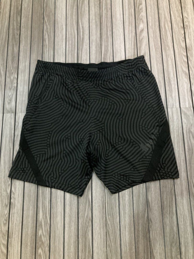 Nike Dri-FIT Patterned Athletic Shorts Size L (Category: Shorts) located in Trece Martires City. Submitted by thriftkoto.91 (Listing ID 1466256361, Image 1). Description: Nike Dri-FIT athletic shorts in black with a wavy fingerprint style graphic pattern throughout. Size large tag inside waistband. Elastic waist design with solid black side panels and reflective Nike swoosh logo near the hem. Made in Cambodia from lightweight moisture-wicking fab