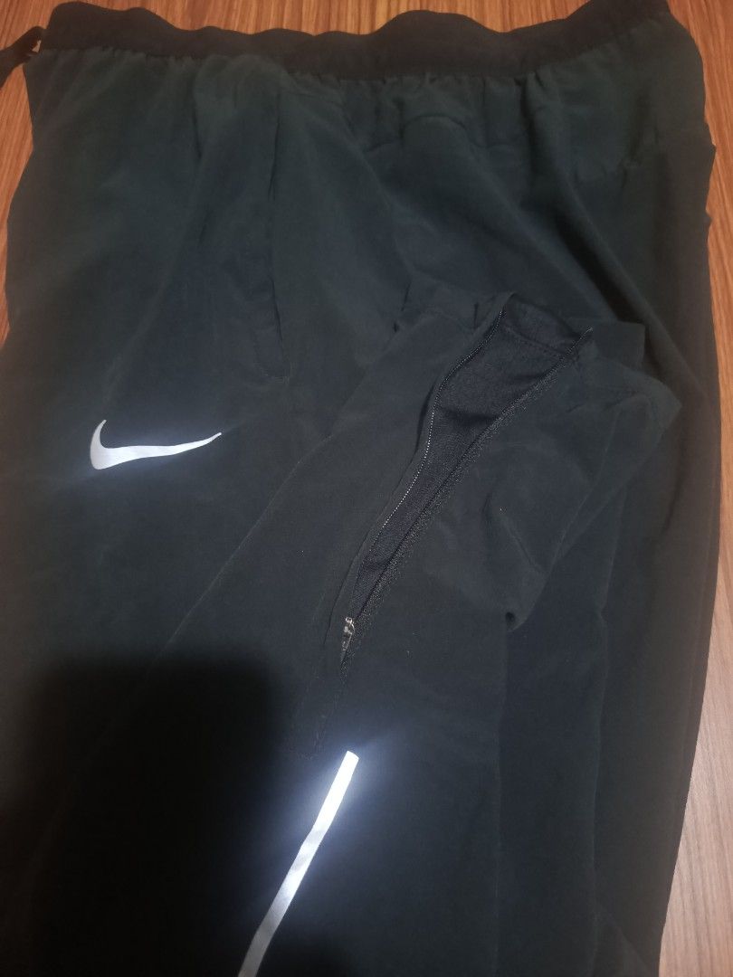Nike Dri-FIT Running Pants Black Size M (Category: Joggers) located in Pasig City. Submitted by atmclick (Listing ID 1466291419, Image 2). Description: - Brand: Nike - Item: Dri-FIT Running Pants - Color: Black - Size: Medium -waist 15 to 17 waist/ length 37 - Condition: Excellent / Pre-loved - Elastic waistband with Nike Running branded adjustable drawstring - Secure zippered back pocket for essentials - Zippered leg cuffs with reflective stripi