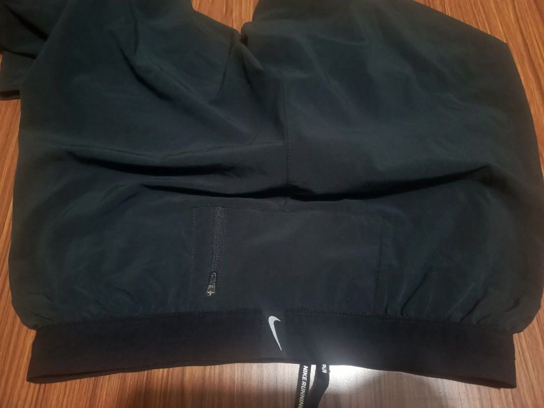 Nike Dri-FIT Running Pants Black Size M (Category: Joggers) located in Pasig City. Submitted by atmclick (Listing ID 1466291419, Image 3). Description: - Brand: Nike - Item: Dri-FIT Running Pants - Color: Black - Size: Medium -waist 15 to 17 waist/ length 37 - Condition: Excellent / Pre-loved - Elastic waistband with Nike Running branded adjustable drawstring - Secure zippered back pocket for essentials - Zippered leg cuffs with reflective stripi