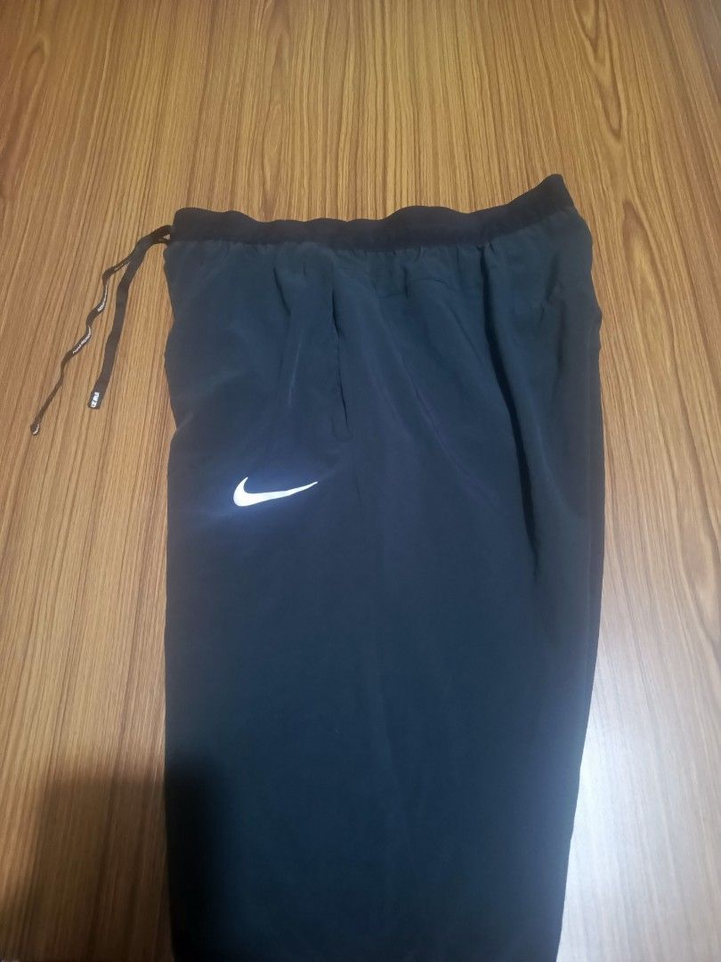 Nike Dri-FIT Running Pants Black Size M (Category: Joggers) located in Pasig City. Submitted by atmclick (Listing ID 1466291419, Image 1). Description: - Brand: Nike - Item: Dri-FIT Running Pants - Color: Black - Size: Medium -waist 15 to 17 waist/ length 37 - Condition: Excellent / Pre-loved - Elastic waistband with Nike Running branded adjustable drawstring - Secure zippered back pocket for essentials - Zippered leg cuffs with reflective stripi