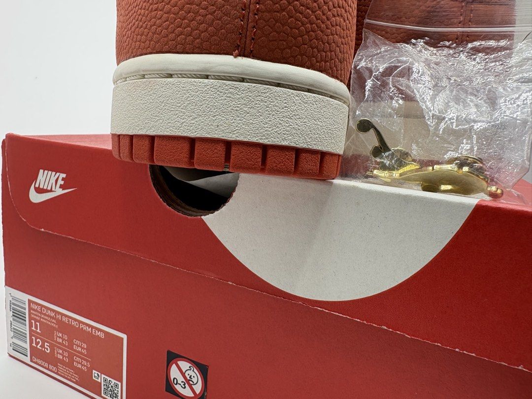 Nike Dunk High Retro PRM EMB Mantra Orange Size 11 (Category: Sneakers) located in Manila. Submitted by rob.fesalbon (Listing ID 1466250073, Image 3). Description: - Model: Nike Dunk High Retro PRM EMB (Mantra Orange / Sail White) - Size: US 11 Men's - Condition: Brand new (tried on) - Inclusions: Original box and accessories (NBA and WNBA logo button pins) - Features: Premium basketball texture overlay panels.