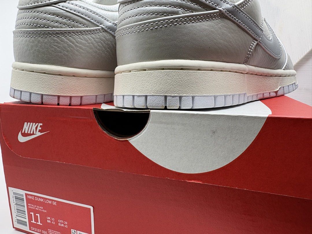 Nike Dunk Low SE Metallic Silver (Category: Sneakers) located in Manila. Submitted by rob.fesalbon (Listing ID 1466249608, Image 3). Description: - Brand: Nike Dunk Low SE - Colorway: Metallic Silver / White / Grey - Size: US 11 / UK 10 / EUR 45 - Condition: Never worn, deadstock with original red Nike shoebox - Details: Textured leather upper, vintage-style aged midsole, white laces, clean soles (minor dust on bottom heel edge from storage) - Au