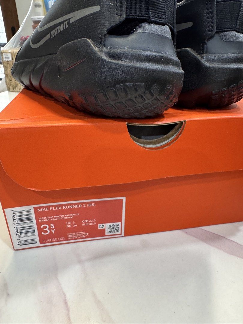 Nike Flex Runner 2 GS Black Flat Pewter (Category: Sneakers) located in San Juan City. Submitted by khaye1123 (Listing ID 1466160163, Image 3). Description: - Brand: Nike - Model: Flex Runner 2 GS - Color: Black and Flat Pewter Anthracite - Size: UK 3 / BR 34 / EUR 35.5 / CM 22.5 - Design: Slip-on with a wide branded strap and pull tabs for easy wear - Inclusions: Comes with original orange Nike shoebox - Condition: Excellent / Well-maintained.