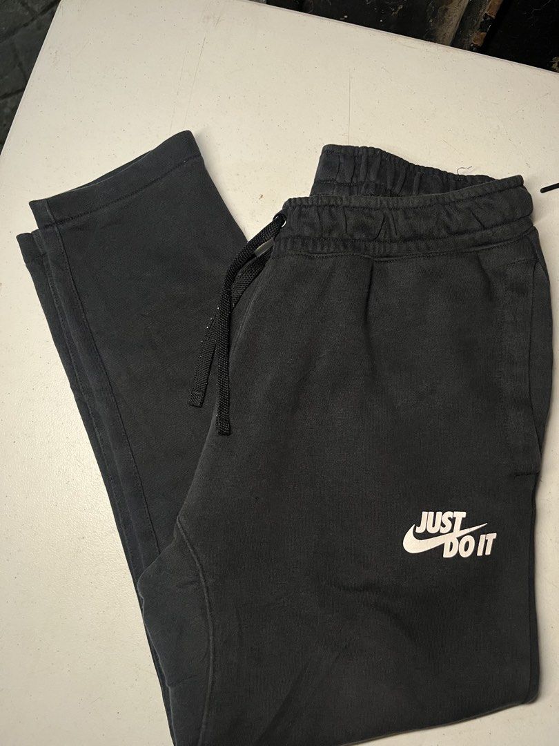Nike Just Do It Black Sweatpants (Category: Joggers) located in Pasay City. Submitted by Oboyyy (Listing ID 1466192818, Image 1). Description: - Brand: Nike - Style/Product Code: AJ2330-010 - Color: Black with white 'Just Do It' logo near the left pocket - Size: Medium (Regular Fit) - Material: Super comfortable cotton blend - Features: Adjustable drawstring waistband and ribbed ankle cuffs - Condition: Excellent with clean interior labels intact
