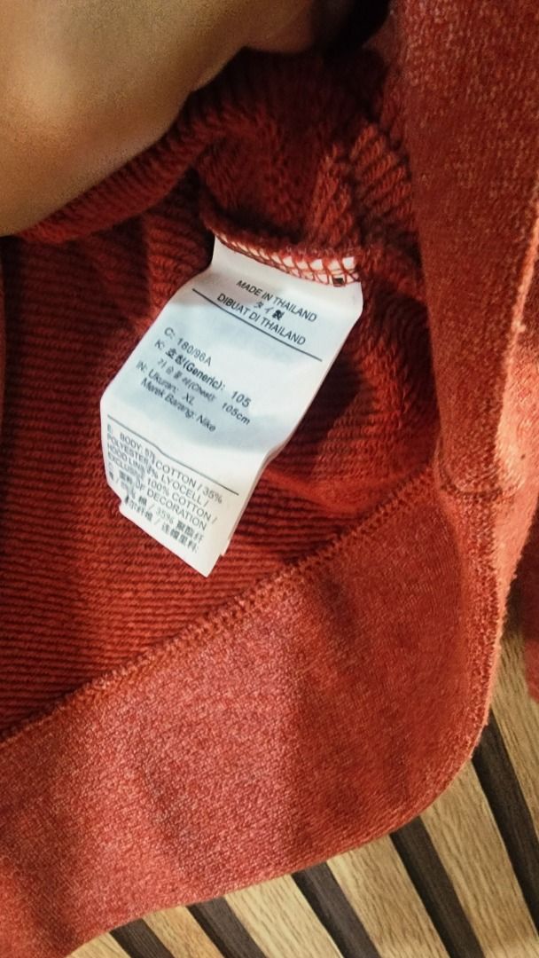 Nike Red Hoodie Size XL (Category: Hoodies) located in Baguio. Submitted by genesisomega (Listing ID 1466277640, Image 3). Description: - Brand: Nike - Color: Red - Size: XL (Standard fit) - Material: Cotton & polyester blend body with 100% cotton hood lining - Origin: Made in Thailand - Condition/Details: Includes original tag showing size and material specs - Ideal for: Comfortable daily wear and casual styling.