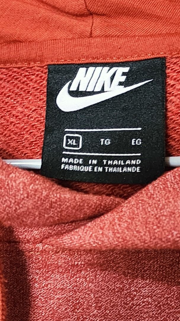 Nike Red Hoodie Size XL (Category: Hoodies) located in Baguio. Submitted by genesisomega (Listing ID 1466277640, Image 2). Description: - Brand: Nike - Color: Red - Size: XL (Standard fit) - Material: Cotton & polyester blend body with 100% cotton hood lining - Origin: Made in Thailand - Condition/Details: Includes original tag showing size and material specs - Ideal for: Comfortable daily wear and casual styling.