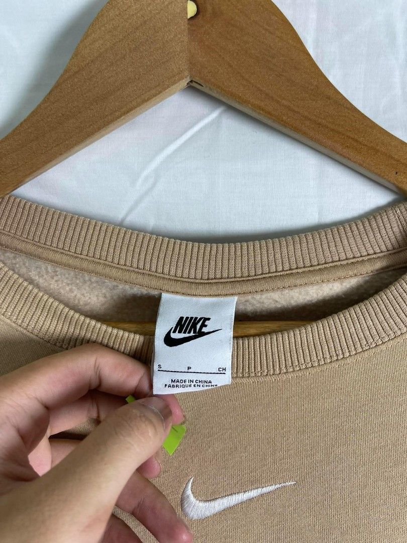 Nike Tan Crewneck Sweatshirt Size S (Category: Coats, Jackets and Outerwear) located in Manila. Submitted by japee55 (Listing ID 1466321539, Image 3). Description: - Brand: Nike - Style: Crewneck sweatshirt - Color: Tan with embroidered white logo on chest - Size: Small (S) - Material: 80% cotton, 20% polyester (Made in China) - Features: Cozy fleece interior, ribbed collar, cuffs, and hem - Condition: Excellent / Ready to ship.