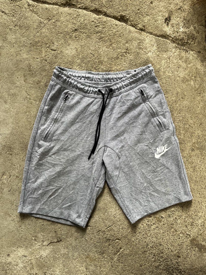 Nike Tech Fleece Grey Shorts (Category: Shorts) located in Calabanga. Submitted by jijithriftcamarinessur (Listing ID 1466225491, Image 1). Description: - Authentic grey Nike shorts - Secure zippered side pockets plus a back pocket - Adjustable drawstring waistband with black tips - Textured fabric with paneled crotch design for maximum mobility and comfort - White Nike logo printed on the left leg.