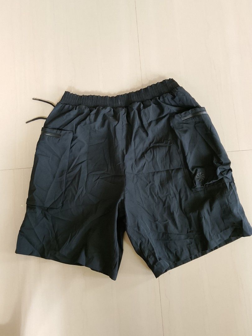 Nike Tech Pack Black Utility Shorts Size M (Category: Shorts) located in Manila. Submitted by arjaygoodfind (Listing ID 1466243937, Image 2). Description: - Brand/Model: Nike Tech Pack Shorts (Style Code: FB7529-010) - Color: Black - Size: Medium (M) - Material: 100% lightweight polyester - Fit: Elastic waistband with adjustable drawstring - Storage: Multiple utility cargo pockets with secure zippers - Condition: Clean, tags intact - Ideal for: G