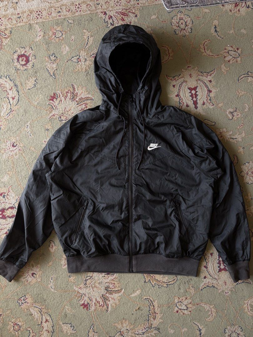Nike windrunner triple black colorway embroid logo (Category: Coats, Jackets and Outerwear) located in General Santos City (Dadiangas). Submitted by scrtshp (Listing ID 1466174635, Image 1). Description: 24x25 Size M on tag, Can fit till XL actual no issue/In excellent condition washed & ready to wear ribbings not faded, design po yung parang light color sa ribbings.