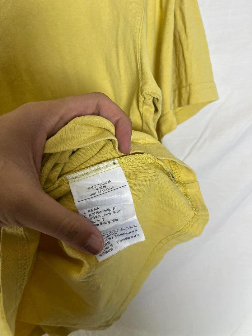 Nike Yellow The Nike Tee Small (Category: Tshirts & Polo Shirts ) located in Manila. Submitted by japee55 (Listing ID 1466320937, Image 3). Description: - Brand: Nike (The Nike Tee collection) - Size: Small - Color: Bright Yellow with black embroidered swoosh - Material: 100% Cotton, Made in China - Fit: Regular fit, short sleeves, crew neck - Condition: Clean and well-maintained.