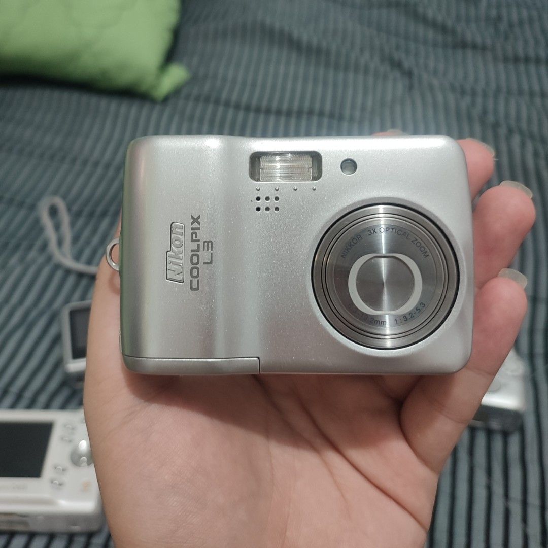 Nikon Coolpix L3 Digital Camera (Category: Cameras) located in Manila. Submitted by declutteringmikkyyy (Listing ID 1466318385, Image 2). Description: - Model: Silver Nikon Coolpix L3 compact digital camera - Power: Runs on standard AA batteries - Condition: Tested and working, with minimal scratches (normal for second hand) and a very small dot on the screen not visible when turned on and output not affected - Inclusions: Unit itself and origina