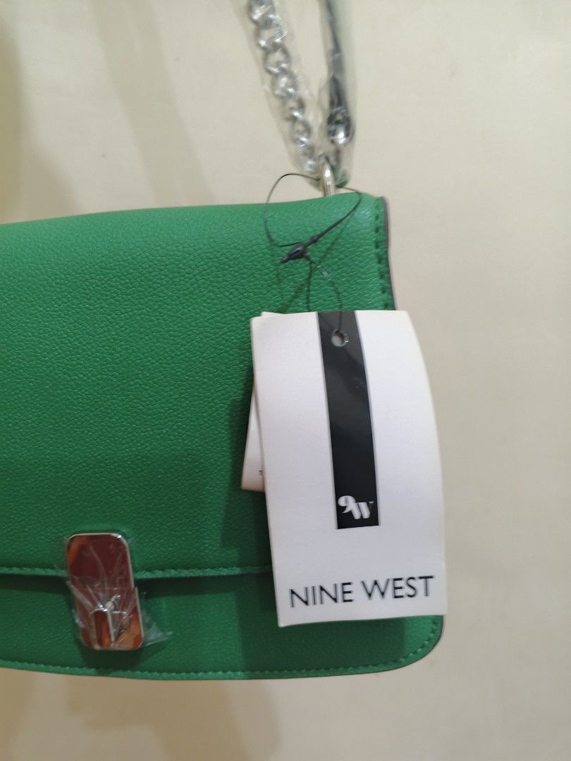 Nine West Green Shoulder Bag (Category: Shoulder Bags) located in Bacoor. Submitted by stardys8888 (Listing ID 1466289204, Image 2). Description: - Brand: Nine West - Color: Bright green - Material: Textured faux leather - Hardware: Silver-tone with protective plastic still attached - Strap: Silver chain shoulder strap - Condition: Brand new with tags, pristine exterior, clean interior - Closure: Structured flap with metal clasp.