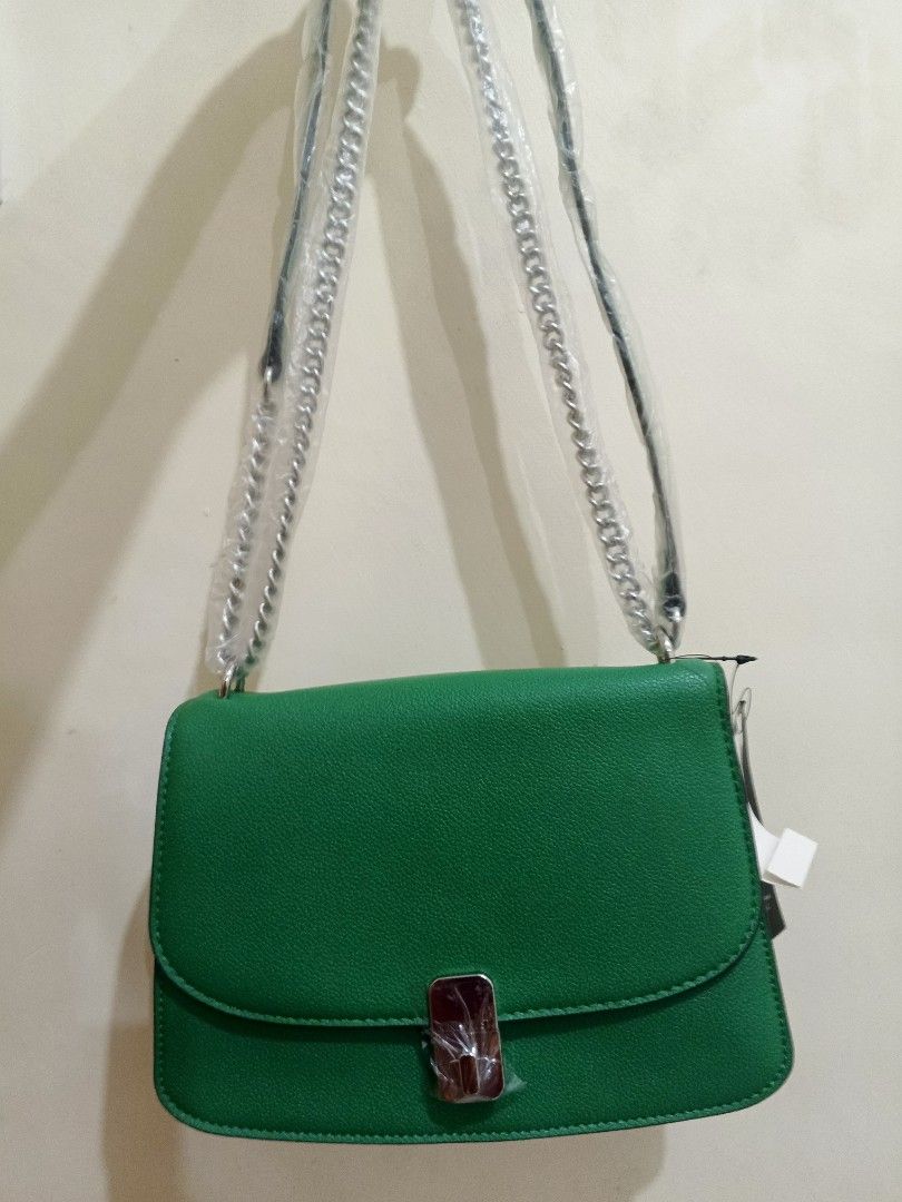Nine West Green Shoulder Bag (Category: Shoulder Bags) located in Bacoor. Submitted by stardys8888 (Listing ID 1466289204, Image 1). Description: - Brand: Nine West - Color: Bright green - Material: Textured faux leather - Hardware: Silver-tone with protective plastic still attached - Strap: Silver chain shoulder strap - Condition: Brand new with tags, pristine exterior, clean interior - Closure: Structured flap with metal clasp.