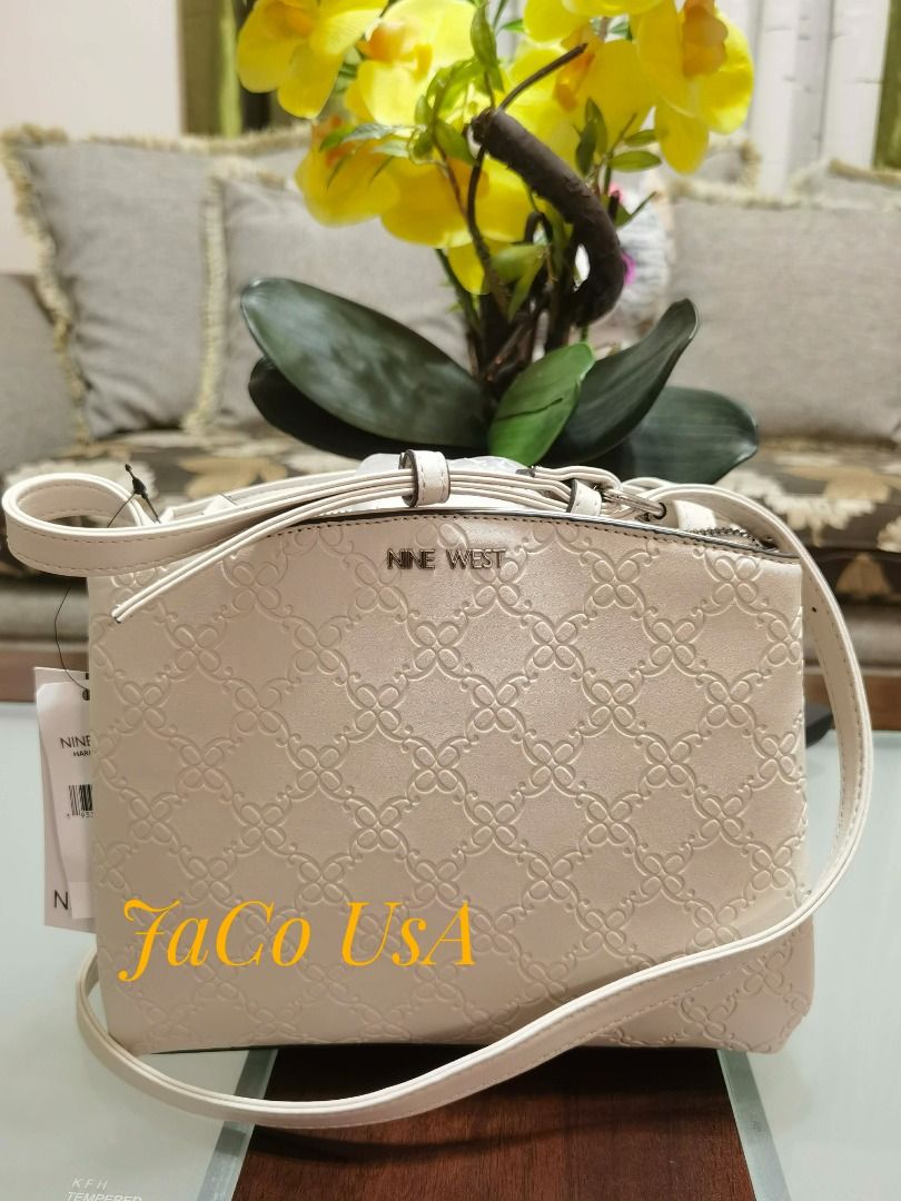 Nine West Harmoni Mini Crossbody (Category: Cross-body Bags) located in Taytay. Submitted by itsjacousa (Listing ID 1466290862, Image 1). Description: - Color: Cream - Design: Embossed geometric flower pattern with a structured dome shape - Closure: Secure top zip - Strap: Long, adjustable shoulder strap.