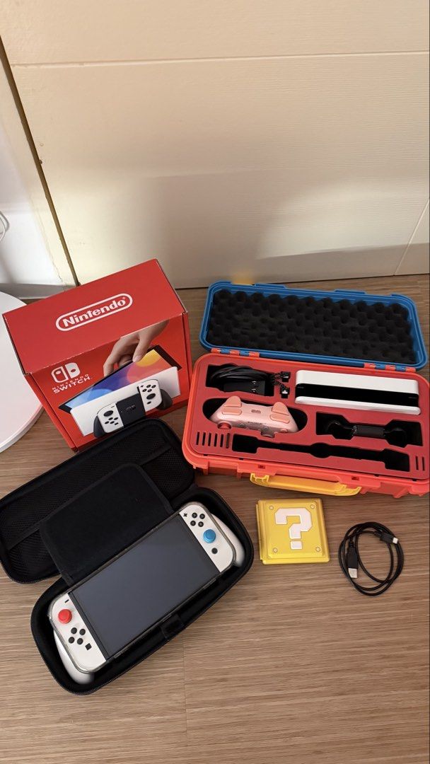 Nintendo Switch OLED Model White with Dock and Accessories (Category: Nintendo) located in Marikina City. Submitted by angel.archives (Listing ID 1465063562, Image 3). Description: NINTENDO SWITCH OLED WHITE - Nintendo Switch OLED White with white Joy-Cons - Original box - Dock, charger, and HDMI cable - Joy-Con grip and wrist straps - Black carrying case - Console carrying case - Dobe Pink console - No scratches and no repair history. Switch gam