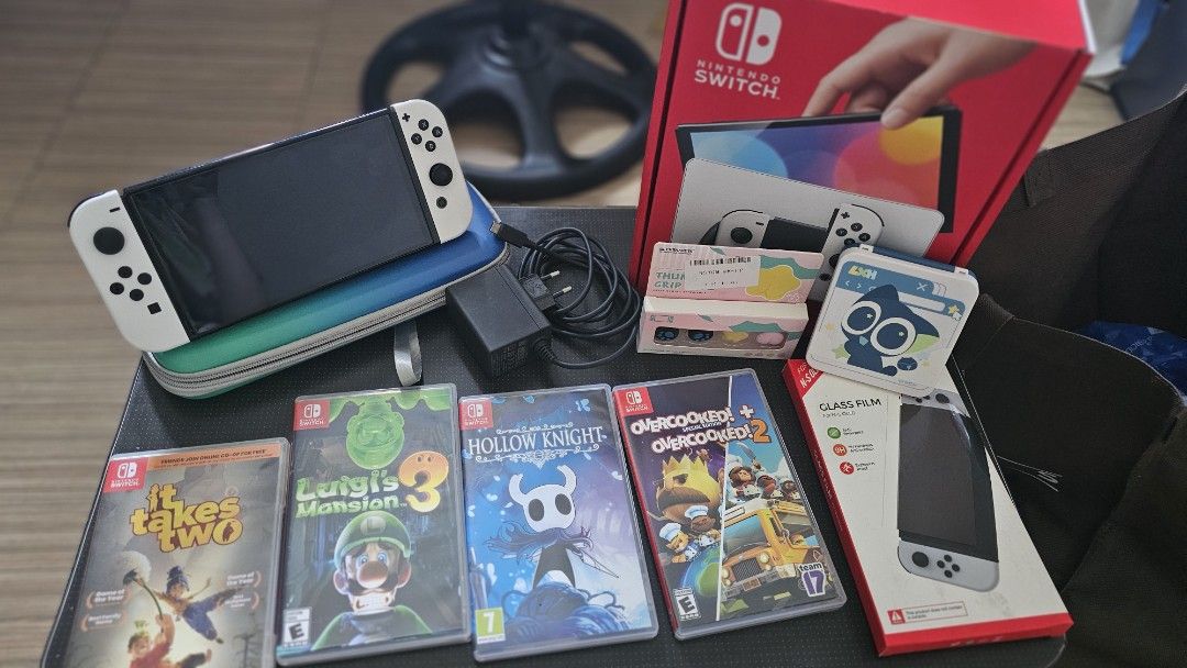 Nintendo Switch OLED Model (with games) (Category: Nintendo) located in Manila. Submitted by dettelyhallows (Listing ID 1466199498, Image 1). Description: Nintedo Switch OLED Model White Comes with: - Joy-Cons (L/R) - Joy-Con Straps (L/R) - High Speed HDMI Cable - Nintendo Switch dock (with LAN port) - Joy-Con Grip - Nintendo Switch AC Adapter - Protective Case - Card case - Thumb grips - Tempered glass 4 games: - Overcooked! + Overcooked! 2 - Ho