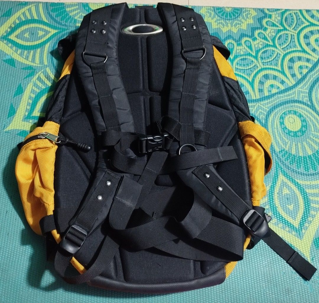 Oakley Software Yellow Black Backpack (Category: Backpacks) located in Taguig. Submitted by giango1313 (Listing ID 1466257535, Image 2). Description: - Brand: Oakley Software - Colorway: Striking yellow and black - Design: Rugged build with textured fabric and reinforced bottom panels - Storage: Multiple exterior utility straps, integrated mesh pockets, and official woven interior tag - Comfort: Padded shoulder straps with sternum strap and metal
