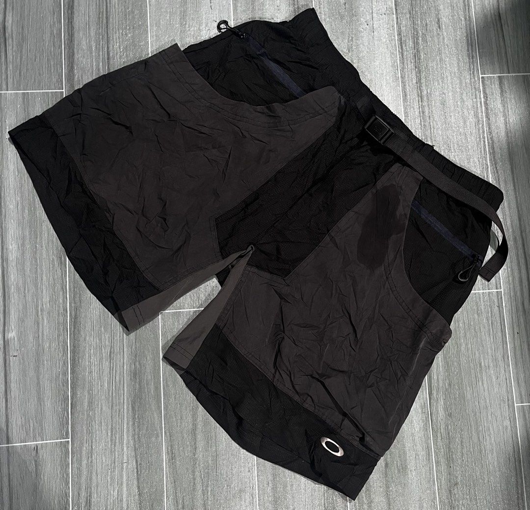 Oakley Technical Cargo Shorts Black Regular Fit Size S (Category: Shorts) located in Cabuyao City. Submitted by undergroundthrift03 (Listing ID 1466319469, Image 1). Description: - Brand: Oakley - Color: Black - Style: Technical shorts with built-in belt and buckle closure - Fit: Regular fit with adjustable waist - Material: Lightweight nylon ripstop (polyester, polyamide, elastane blend) - Storage: Multiple utility pockets with secure zip closur