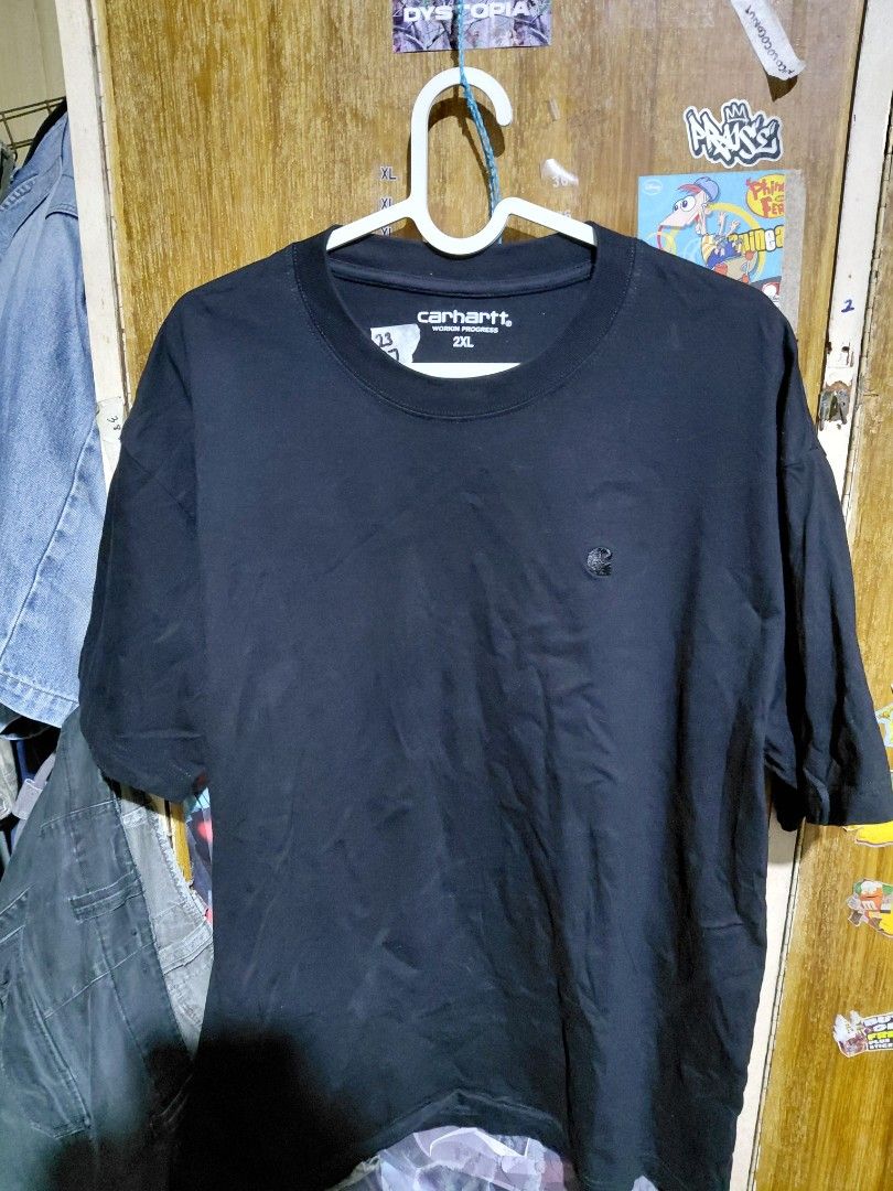 OFF Carhartt Work In Progress 2XL Black T-Shirt (Category: Tshirts & Polo Shirts ) located in Imus. Submitted by frootiloots4103 (Listing ID 1466313208, Image 1). Description: - Brand: Carhartt Work In Progress (WIP) - Color: Solid black - Size: 2XL (Regular fit) - Design: Classic crew neck with small embroidered Carhartt logo patch on chest - Measurements: 23" width x 27" length (handwritten on tape inside neckline) - Condition: Good, ready to w