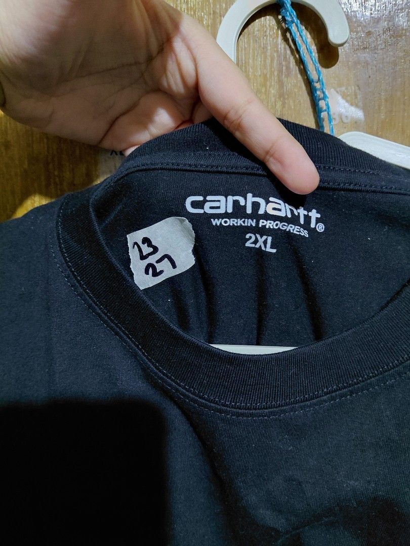 OFF Carhartt Work In Progress 2XL Black T-Shirt (Category: Tshirts & Polo Shirts ) located in Imus. Submitted by frootiloots4103 (Listing ID 1466313208, Image 3). Description: - Brand: Carhartt Work In Progress (WIP) - Color: Solid black - Size: 2XL (Regular fit) - Design: Classic crew neck with small embroidered Carhartt logo patch on chest - Measurements: 23" width x 27" length (handwritten on tape inside neckline) - Condition: Good, ready to w