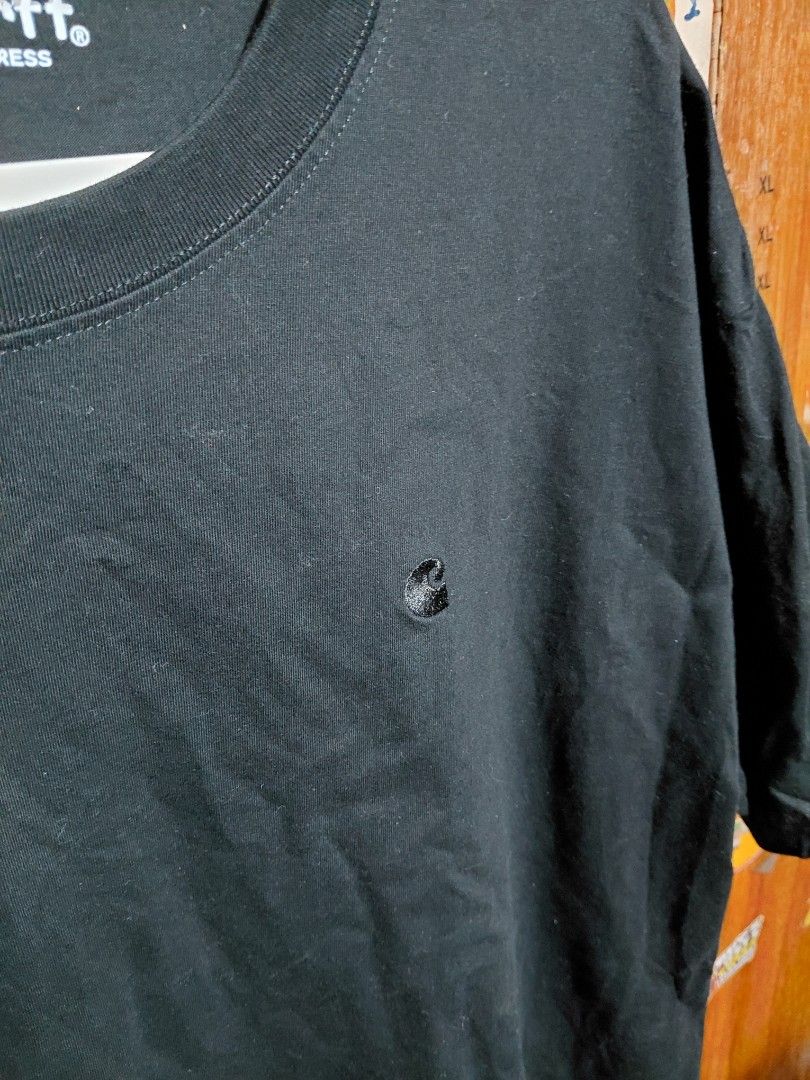 OFF Carhartt Work In Progress 2XL Black T-Shirt (Category: Tshirts & Polo Shirts ) located in Imus. Submitted by frootiloots4103 (Listing ID 1466313208, Image 2). Description: - Brand: Carhartt Work In Progress (WIP) - Color: Solid black - Size: 2XL (Regular fit) - Design: Classic crew neck with small embroidered Carhartt logo patch on chest - Measurements: 23" width x 27" length (handwritten on tape inside neckline) - Condition: Good, ready to w