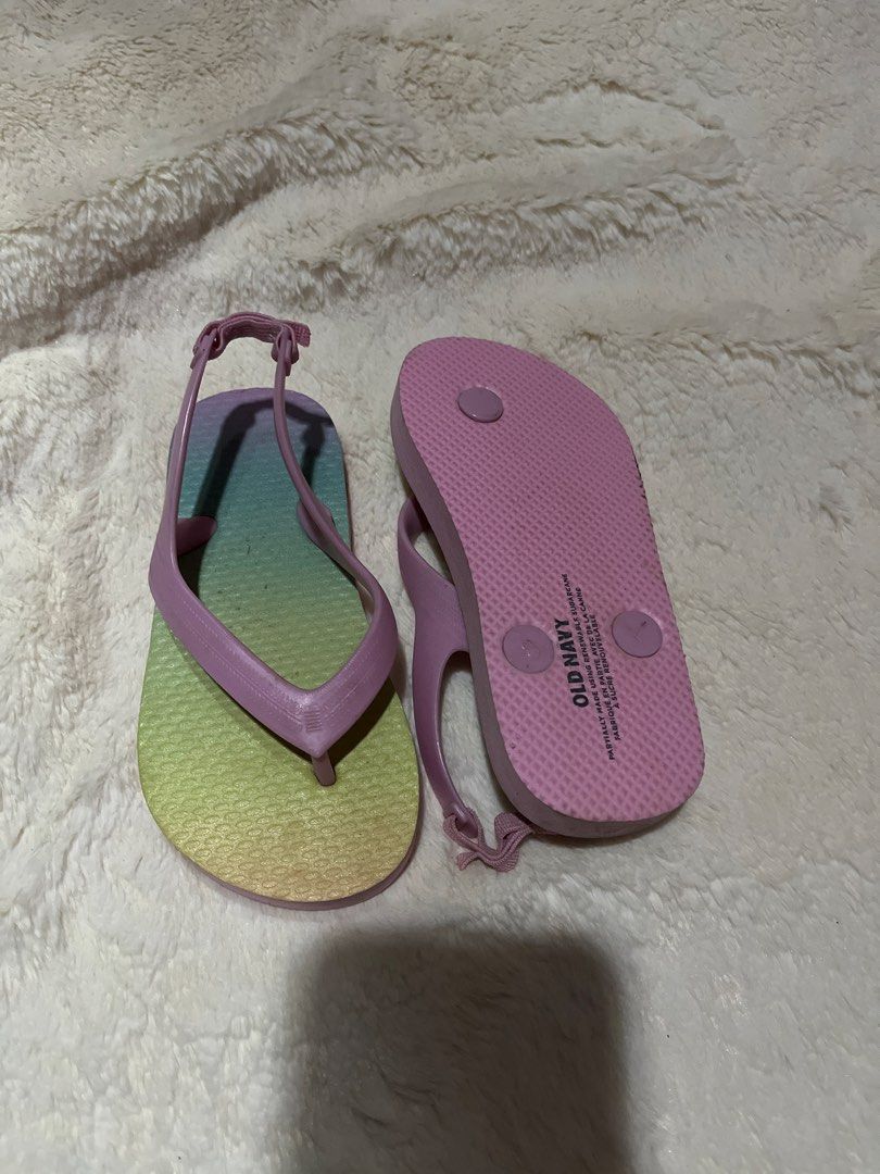 Old Navy Kids Rainbow Gradient Flip Flops Size 8 (Category: Babies & Kids Fashion) located in Carmona. Submitted by abimeng08 (Listing ID 1466302818, Image 2). Description: -unised - Brand: Old Navy - Size: 8 (stamped on bottom) - Design: Blue, green, and yellow gradient pattern with soft pink straps - Features: Back strap for a secure fit, textured footbed for grip, and eco-friendly sugarcane material - Ideal for: Sunny days, beach trips, and po