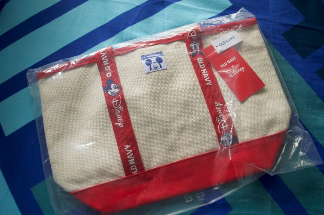 Old Navy x Disney Mickey Mouse Tote Bag (Category: Tote Bags) located in Quezon City. Submitted by Ranger28 (Listing ID 1466201404, Image 1). Description: Brand new, sealed Old Navy x Disney Mickey Mouse tote bag. Cream canvas with red bottom and handles, featuring cute Mickey details and a square logo patch. Still in original packaging with swing tag attached..