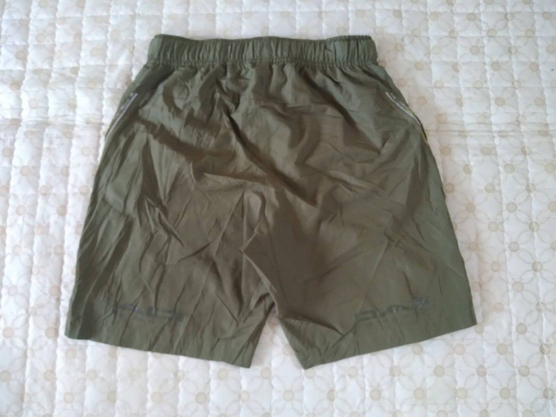 Adidas Gear/Utility Shorts Olive Green Medium (Category: Shorts) located in Zamboanga. Submitted by nurbya898048 (Listing ID 1466256830, Image 3). Description: - Color: Olive green - Material: Lightweight nylon, great for hiking or casual wear - Waist: Elastic waistband with adjustable buckle belt - Pockets: Secure zippered side pockets - Fit: Relaxed fit through the legs - Condition: Clean condition overall with minimal wear.