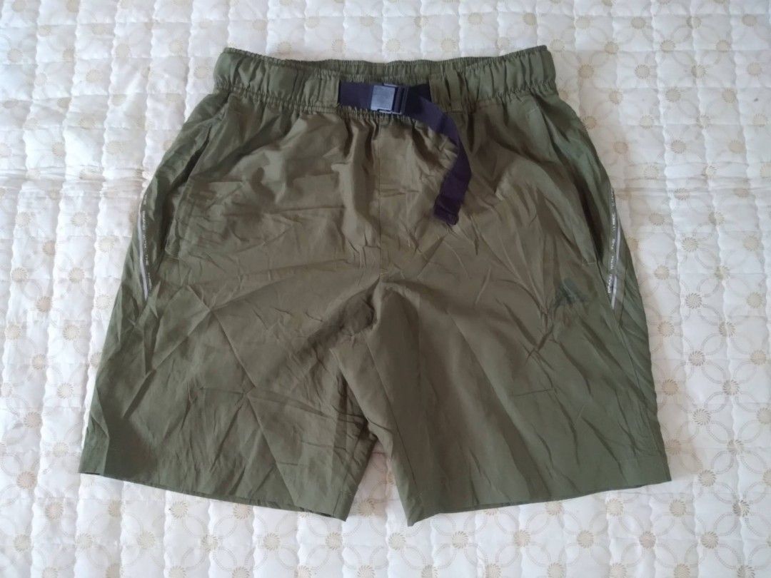 Adidas Gear/Utility Shorts Olive Green Medium (Category: Shorts) located in Zamboanga. Submitted by nurbya898048 (Listing ID 1466256830, Image 2). Description: - Color: Olive green - Material: Lightweight nylon, great for hiking or casual wear - Waist: Elastic waistband with adjustable buckle belt - Pockets: Secure zippered side pockets - Fit: Relaxed fit through the legs - Condition: Clean condition overall with minimal wear.