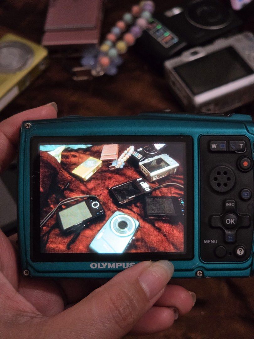 Olympus Stylus Tough Waterproof Digital Camera Blue (Category: Cameras) located in Cebu City. Submitted by jnmryyy (Listing ID 1466295284, Image 2). Description: Teal Olympus Stylus Tough digital camera. Built for shockproof and waterproof action. Rear LCD screen turns on and functions clearly, capturing test shots well. Compact body with standard zoom lens and flash on the front. Handy rubberized texture grip on the back side buttons. Battery do