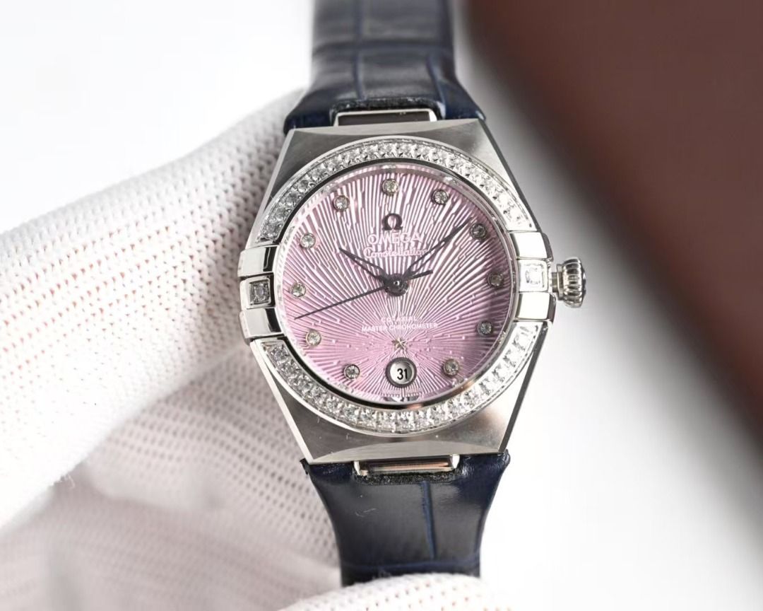 Omega Constellation Master Co-Axial Diamond Watch (Category: Luxury Watches) located in Taguig. Submitted by ivelyskura42711 (Listing ID 1466204429, Image 2). Description: - Brand: Omega Constellation - Strap: Dark blue genuine leather - Case: Stainless steel with diamond-pave bezel - Dial: Sun-brushed pink with diamond hour markers and date window at 6 o'clock - Movement: Automatic co-axial - Condition: Excellent / Pre-loved (ready to wear) - Ve