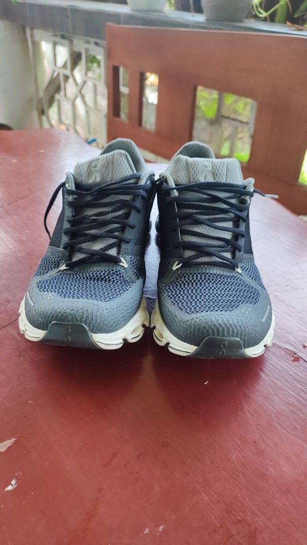 On Cloud Running Shoes (Category: Sneakers) located in Quezon City. Submitted by rapstoreph (Listing ID 1466169226, Image 2). Description: ...not authentic... - Model: Running shoes in Dark Navy and Grey - Size: US W9 / EUR 40.5 (woman size) - Sole: CloudTec setup with distinct white and black pods - Upper: Breathable mesh material for ventilation - Condition: Minor wear on treads and insoles, still plenty of miles left.