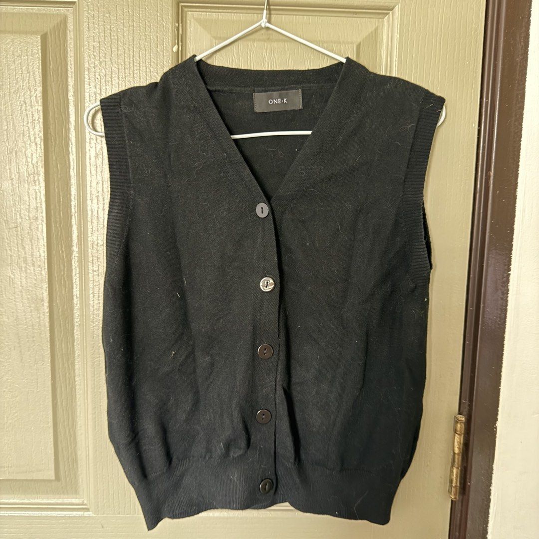ONE-K Black Knit Button-Up Vest (Category: Sleeveless) located in Angeles City. Submitted by elliemnopqrstuv (Listing ID 1466206045, Image 1). Description: - Brand: ONE-K - Color: Classic black - Design: V-neck with 5 front buttons - Details: Ribbed hem and armholes - Material: Soft knit fabric - Fit: Standard fit, great for layering.