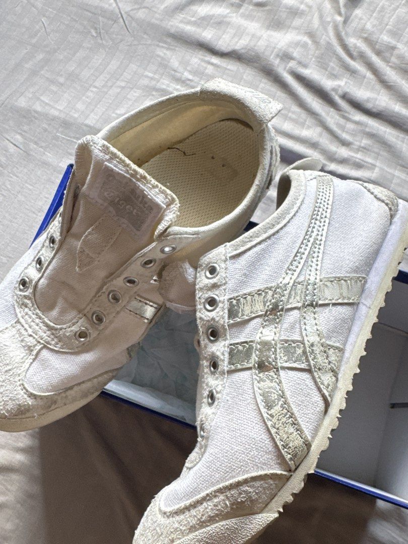 Onitsuka Tiger Mexico 66 White Silver Canvas Shoes (Category: Sneakers) located in Mandaluyong City. Submitted by uol77 (Listing ID 1466161925, Image 2). Description: - Brand: Onitsuka Tiger Mexico 66 - Colorway: White canvas with silver metallic stripes - Details: Suede toe caps and silver heel tabs - Condition: Laces are missing from the metal eyelets - Inclusion: Comes with original blue shoebox.