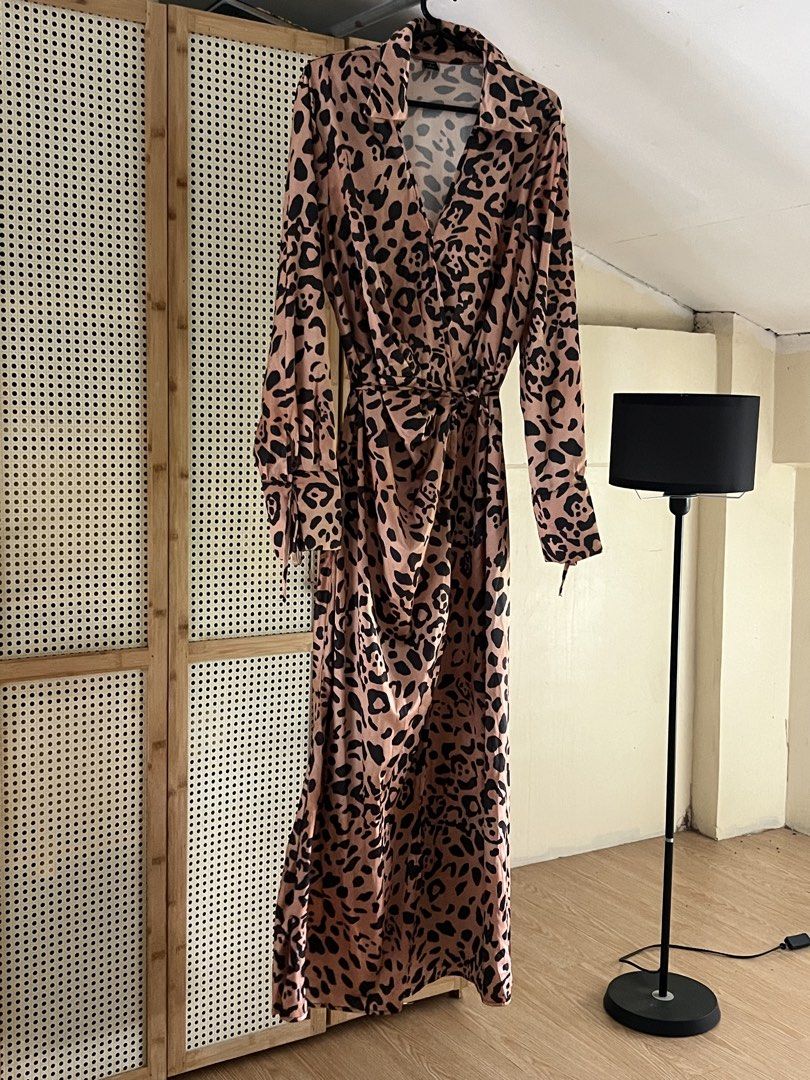 ONTRE Leopard Print Maxi Dress (Category: Dresses) located in Pili. Submitted by gaellecast (Listing ID 1466160035, Image 2). Description: ONTRE wrap midi dress in tan with black leopard print. Collared neckline, long sleeves with button cuffs, matching fabric waist tie. Lightweight satin feel material. Inner lining visible inside. Size M (EU 38, US 6). Made in China. Worn once, still in great shape..