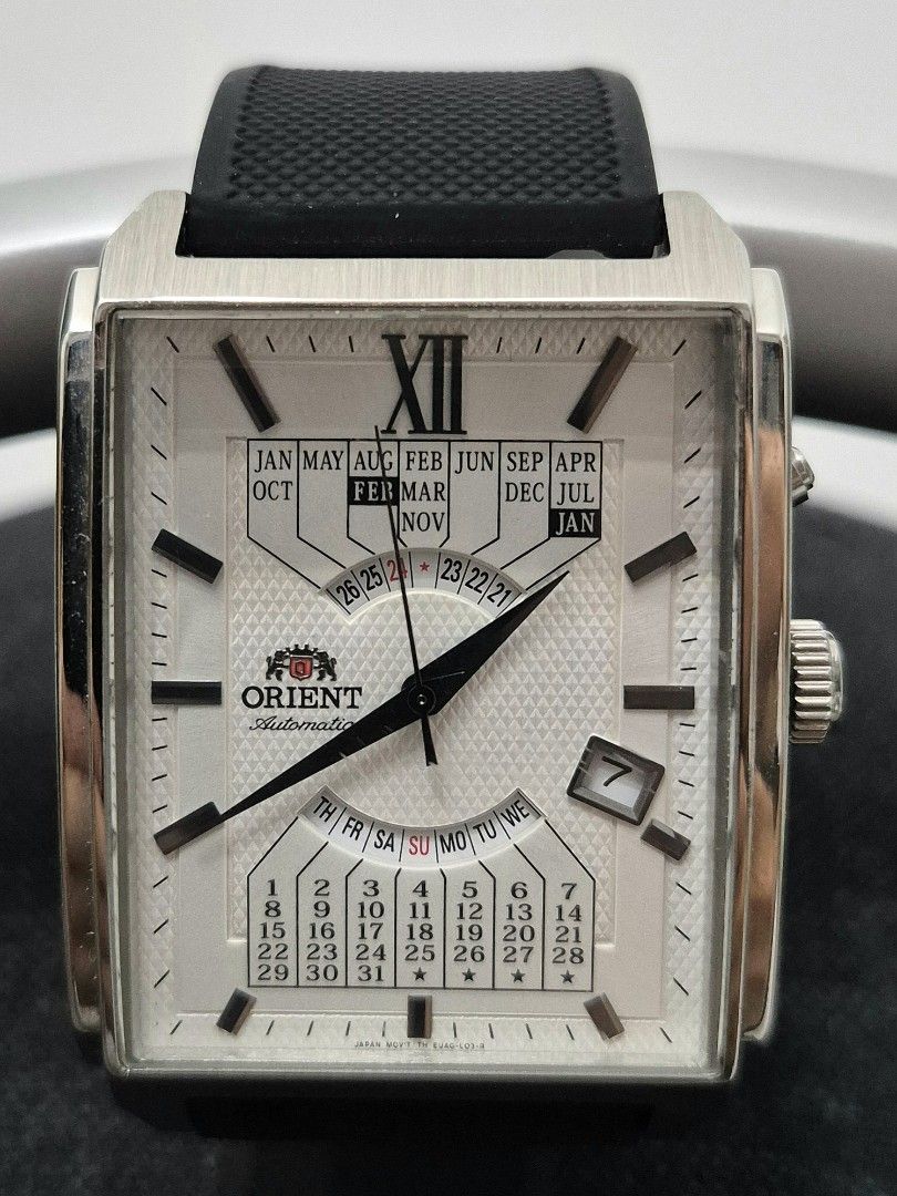Orient Automatic Multi-Year Calendar Rectangular Watch (Category: Watches) located in Kuala Lumpur. Submitted by douglascar (Listing ID 1466322505, Image 1). Description: - Brand: Orient Automatic Watch - Dial: Textured white dial with unique multi-year calendar complication - Case: Rectangular stainless steel case (Note: Noticeable scratches on the case back) - Strap: Comfortable black rubber strap - Features: Date window at the 4 o'clock positi
