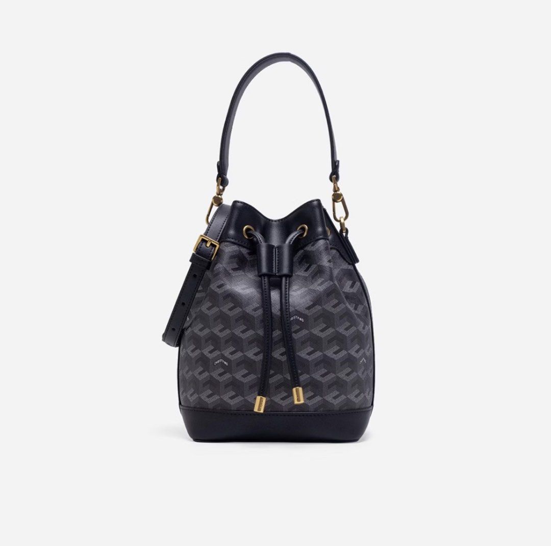 Original Christyng Black Geometric Bucket Bag (Category: Cross-body Bags) located in Pasig City. Submitted by ecyndi (Listing ID 1466248564, Image 1). Description: - Stylish black bucket bag with an all-over geometric pattern - Secure drawstring closure with chic gold-tone hardware - Durable solid black leather-look base and trim - Comes with a convenient top handle and an adjustable shoulder strap - Spacious interior, perfect for carrying all yo