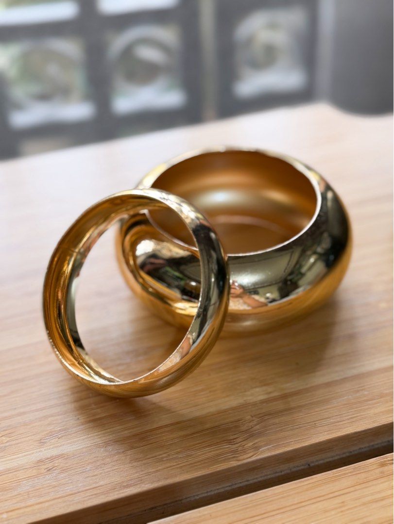 Oversized Gold Bangles (Set of 2) (Category: Accessory Holder, Box & Organizers) located in Pasig City. Submitted by paolasoriano_wind (Listing ID 1466214526, Image 1). Description: Lightly used. Condition: 9/10 (with minimal signs of use) NOT real gold! Fancy jewelry only. Don’t be picky (this is preloved and cheap). Fits small to medium wrist size. Chic and stylish. Wear with oversized tops and polos. See ways to style on last pic. .