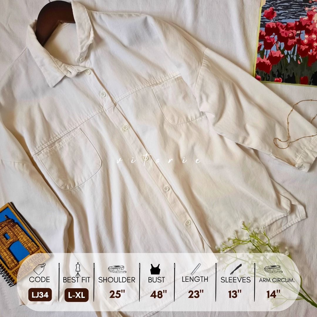 Oversized White Button-Up Shirt with Pockets LJ34 (Category: Shirts) located in Cabuyao City. Submitted by vitorieclothing_lifestyle (Listing ID 1466256201, Image 1). Description: - Style: Oversized white button-up shirt - Design: Classic collar, double chest pockets, dropped shoulders, and half-length sleeves - Fabric: Lightweight, great for layering or casual daily wear - Size: Fits L to XL - Measurements: Shoulder 25", Bust 48", Length 23", Sl