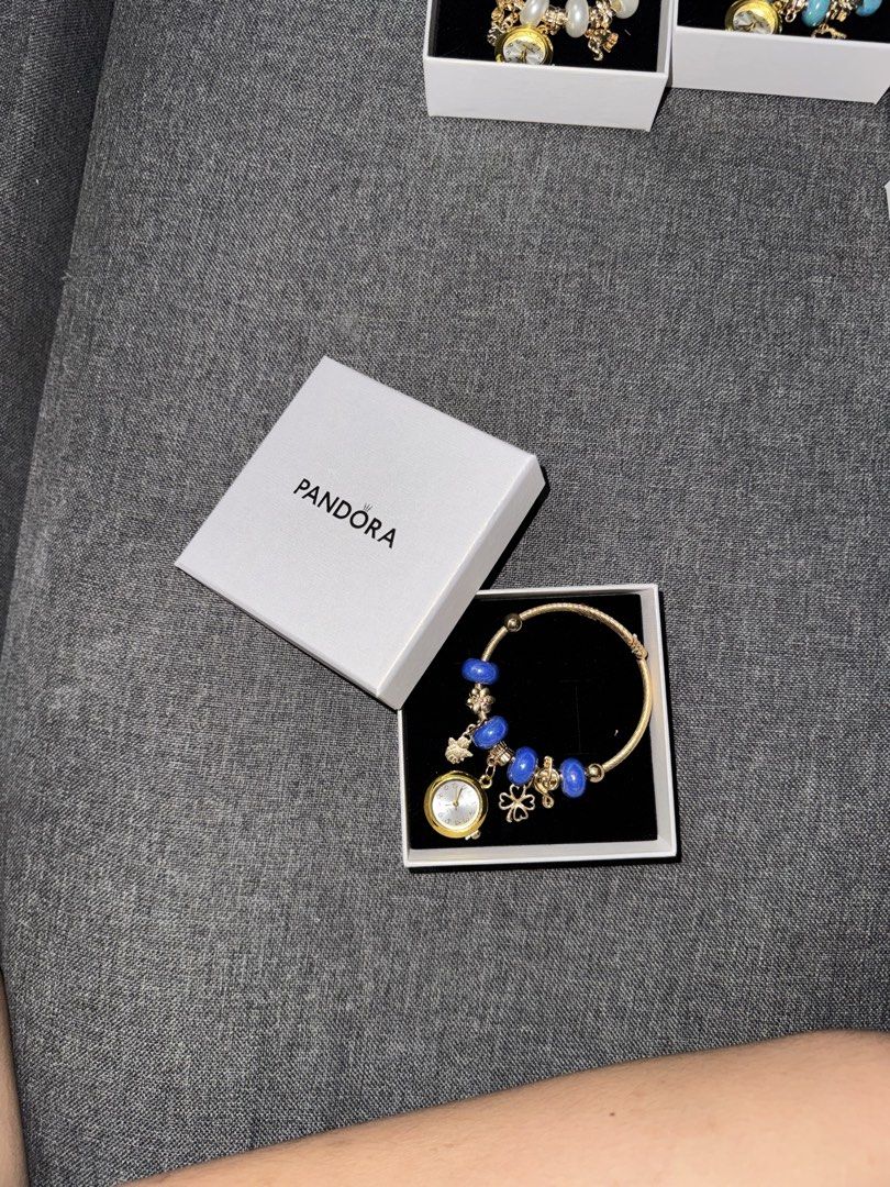 Pandora Bangles with watch (Category: Bracelets) located in Manila. Submitted by youngflower.11acf4 (Listing ID 1466187212, Image 2). Description: - Gold twist-style band with a secure closure - Features a functional watch pendant, clover charm, and beads - Includes official Pandora white presentation box - Ideal for everyday wear or as a thoughtful gift Reminders: ~ Payment First Policy ~ No dp, No reservation ~ No cancelation once you ordered ~