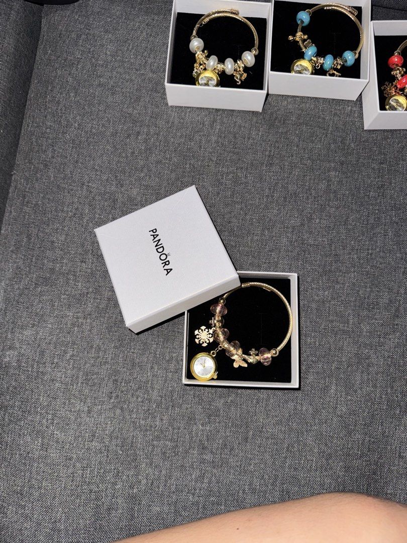 Pandora Bangles with watch (Category: Bracelets) located in Manila. Submitted by youngflower.11acf4 (Listing ID 1466187212, Image 3). Description: - Gold twist-style band with a secure closure - Features a functional watch pendant, clover charm, and beads - Includes official Pandora white presentation box - Ideal for everyday wear or as a thoughtful gift Reminders: ~ Payment First Policy ~ No dp, No reservation ~ No cancelation once you ordered ~