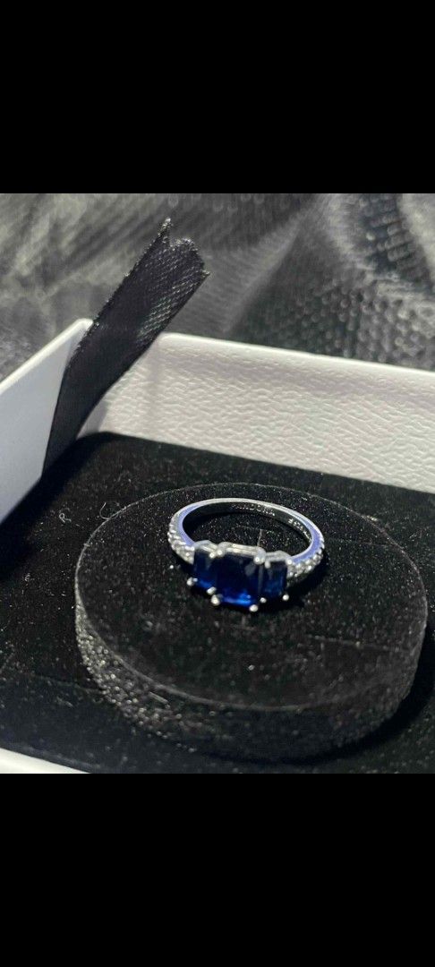 Pandora Blue Crystal Three-Stone Ring (Category: Rings) located in Pasig City. Submitted by magic5 (Listing ID 1466295856, Image 2). Description: - Brand: Authentic Pandora - Material: 925 Sterling Silver (stamped inside band) - Center Design: Three deep blue rectangular stones - Accents: Paved clear stones along the band - Inclusion: Original white Pandora presentation box with black insert - Condition: Excellent, comfortable to wear with striki